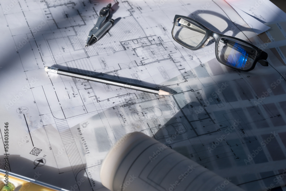 Architect concept, Architects working with blueprints in the office Business accessories (laptop, smartphone, pens, magnifier), accessories for drawing (plans, rulers) and learning on the table Architect concept, Architects working with blueprints in the office Business accessories (laptop, smartphone, pens, magnifier), accessories for drawing (plans, rulers) and learning on the table