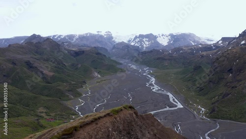 Soaring past mountain ridge with stunning view of Thórsmörk valley in Iceland, aerial photo