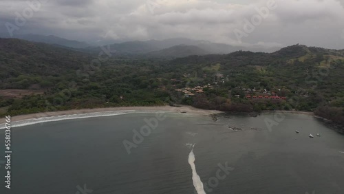 Approaching Playa Carrillo Beach and resorts in West Costa Rica, Aerial dolly in shot photo