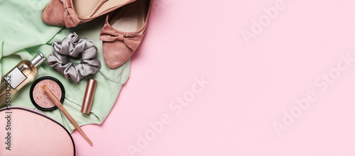 Stylish female clothes, silk scrunchy and makeup cosmetics on pink background with space for text
