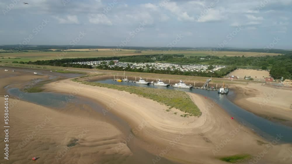 Rotating Drone Shot of Beach at Low Tide with Windmill Maintenance Boats in Small Harbour in Wells-Next-The-Sea North Norfolk UK East Coast Rotating Drone Shot of Beach at Low Tide with Windmill Maintenance Boats in Small Harbour in Wells-Next-The-Sea North Norfolk UK East Coast