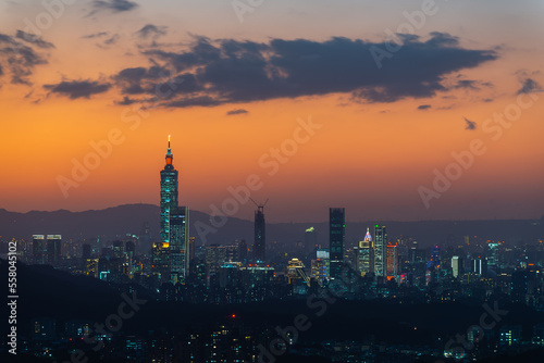 Wallpaper Mural A vibrant cityscape with an orange night sky. Night view of the city surrounded by mountains is hazy and dreamy.. Taipei City, Taiwan Torontodigital.ca