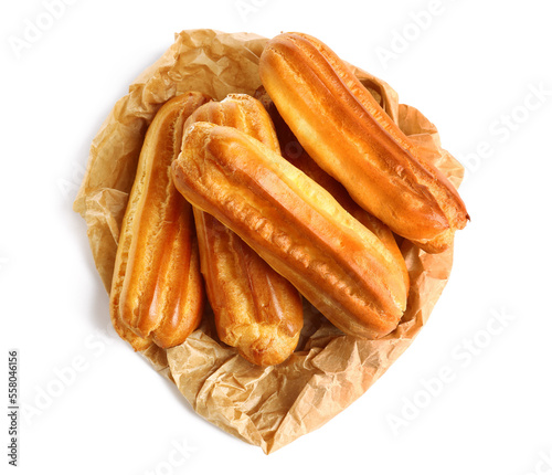Baking paper with sweet eclairs on white background