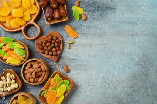 Dried dates, fruits and nuts on rustic background. Top view, flat lay.