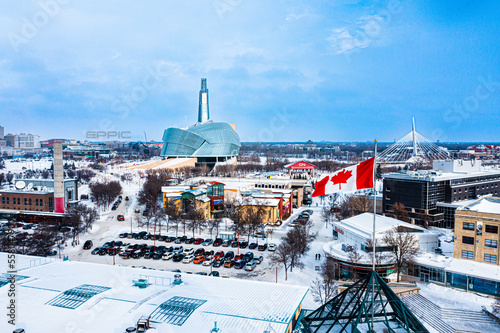 Canadian flag blowing in the wind with Human rights museum in the background.  Winnipeg, Manitoba.  Winter. photo