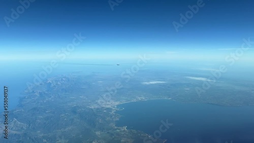 Jet crossing track near Mallorca Island, Spain, Mediterranean sea. Pilot point of view. Blue sky. Sunny day. Recorded at 10000m high.