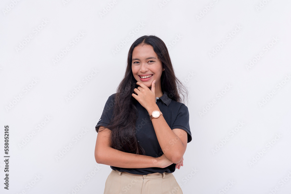 An attractive young female employee looking at the camera with her hand on her chin. A reliable and competent employee in smart casual clothes. Isolated on a white background. An attractive young female employee looking at the camera with her hand on her chin. A reliable and competent employee in smart casual clothes. Isolated on a white background.