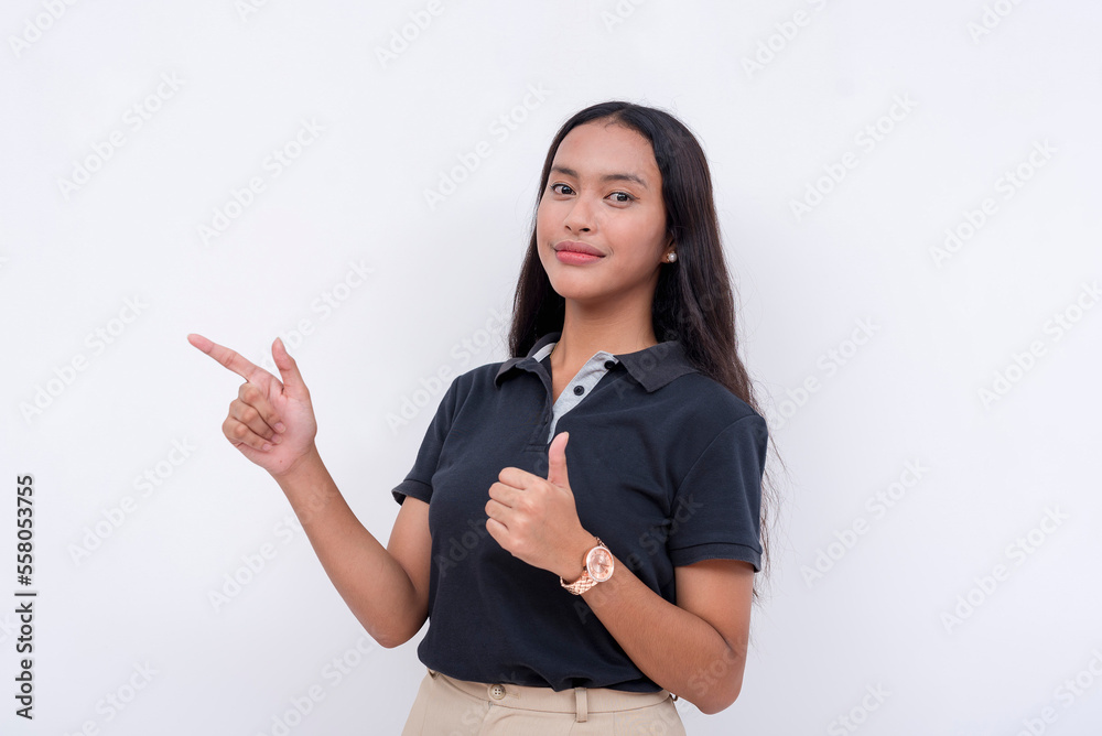 A pensive woman points to the left while giving a thumbs up gesture. Isolated on a white background. A pensive woman points to the left while giving a thumbs up gesture. Isolated on a white background.