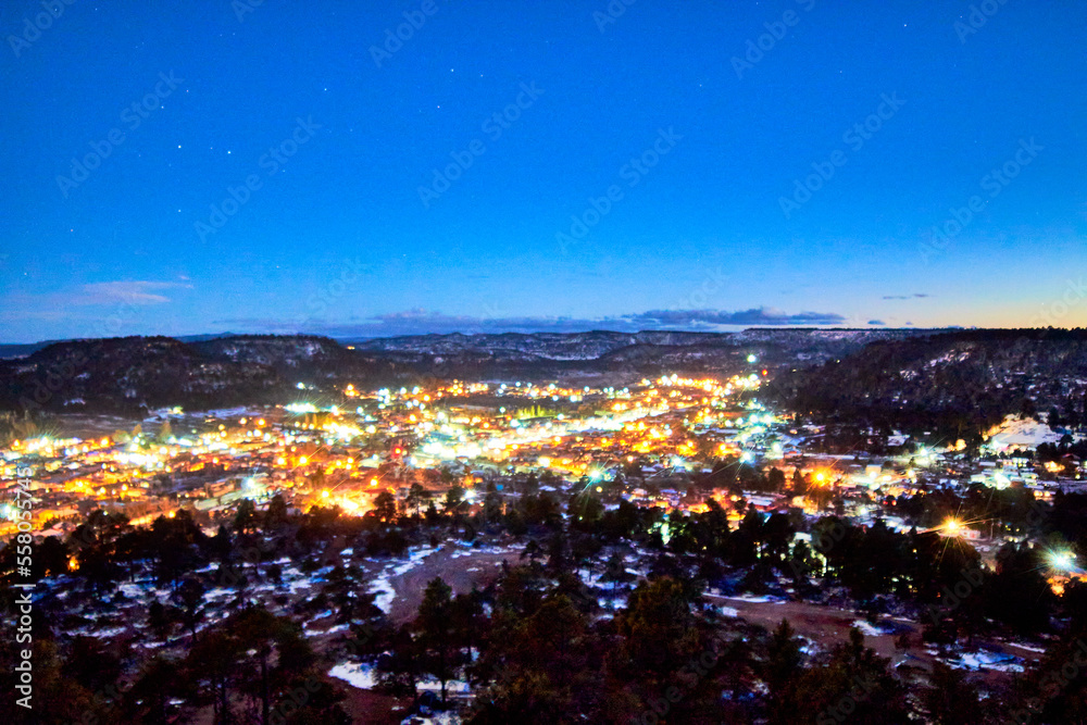 aerial view of downtown at night with bright lights, dark blue sky with stars, winter in creel chihuahua 