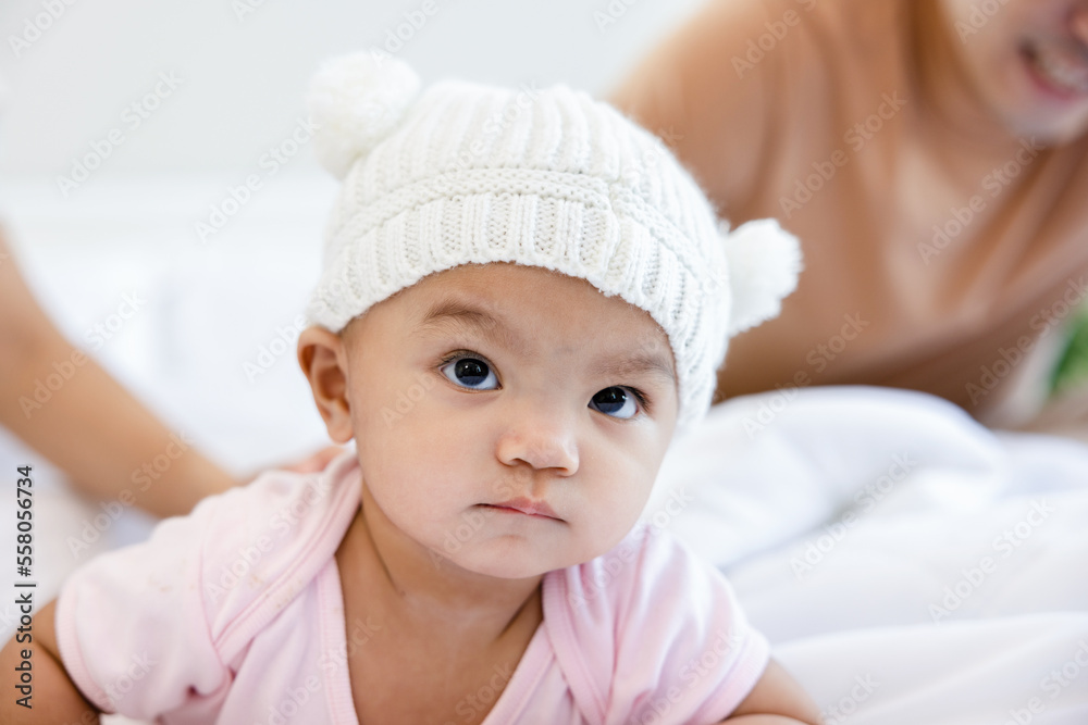 Toddlers are feeling safe and happy with their parents' care in bed at home. Asian family takes care of their children's health with love. Young children are learning to develop their brains. Toddlers are feeling safe and happy with their parents' care in bed at home. Asian family takes care of their children's health with love. Young children are learning to develop their brains.
