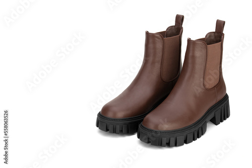 Brown women's leather shoes on a white background. Fashion trend. Winter season half-boots.