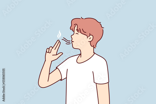 Casual guy teenager puts fingers to lips depicting gun wants to seem like smoker. Youth man lights invisible cigarette suffering from bad habits or nicotine addiction. Flat vector illustration 