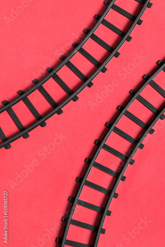 Fototapeta Naklejka Na Ścianę i Meble -  Toy rails on red