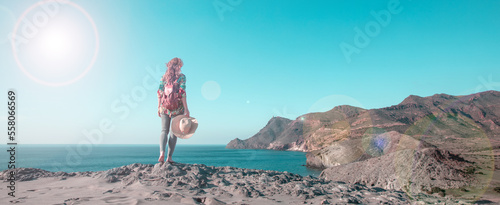 Woman tourist looking at panoramic landscape of Cabo de Gata near Almeria,  Andalusia in Spain- mediterranean sea
