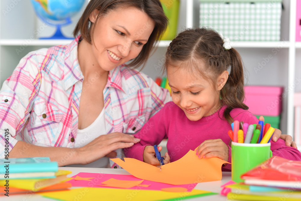Mother teaches her cute daughter to do craft items Mother teaches her cute daughter to do craft items
