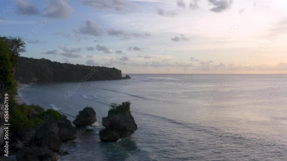 Aerial push-out of cliffs, forest, beach, and open sea in Indonesia Aerial push-out of cliffs, forest, beach, and open sea in Indonesia