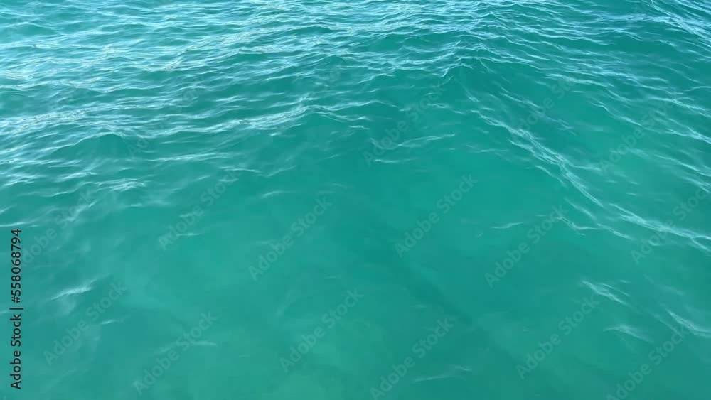 Aerial top down view from high altitude of blue azure turquoise sea water texture. a view of the water surface. Background of the water surface. Aerial top down view from high altitude of blue azure turquoise sea water texture. a view of the water surface. Background of the water surface.