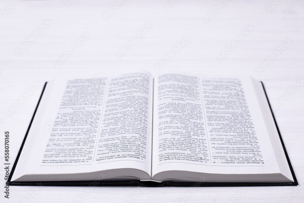 An open Bible on the table. Prayer to pray. On a white background An open Bible on the table. Prayer to pray. On a white background