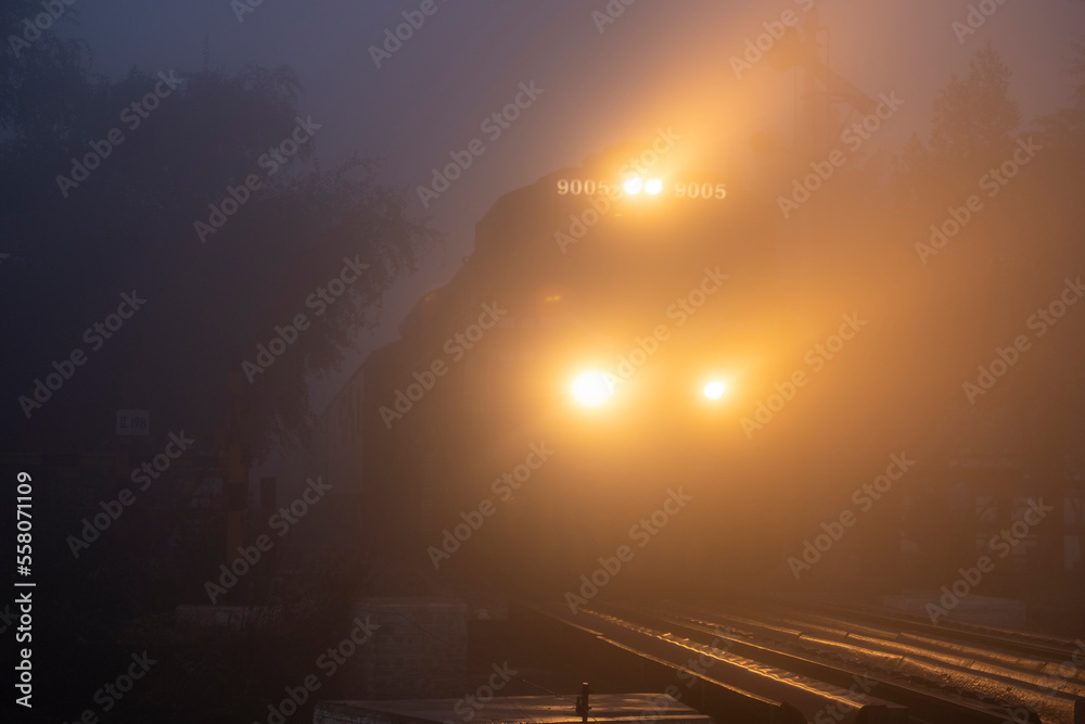 train with lights in the fog , foggy morning with train 