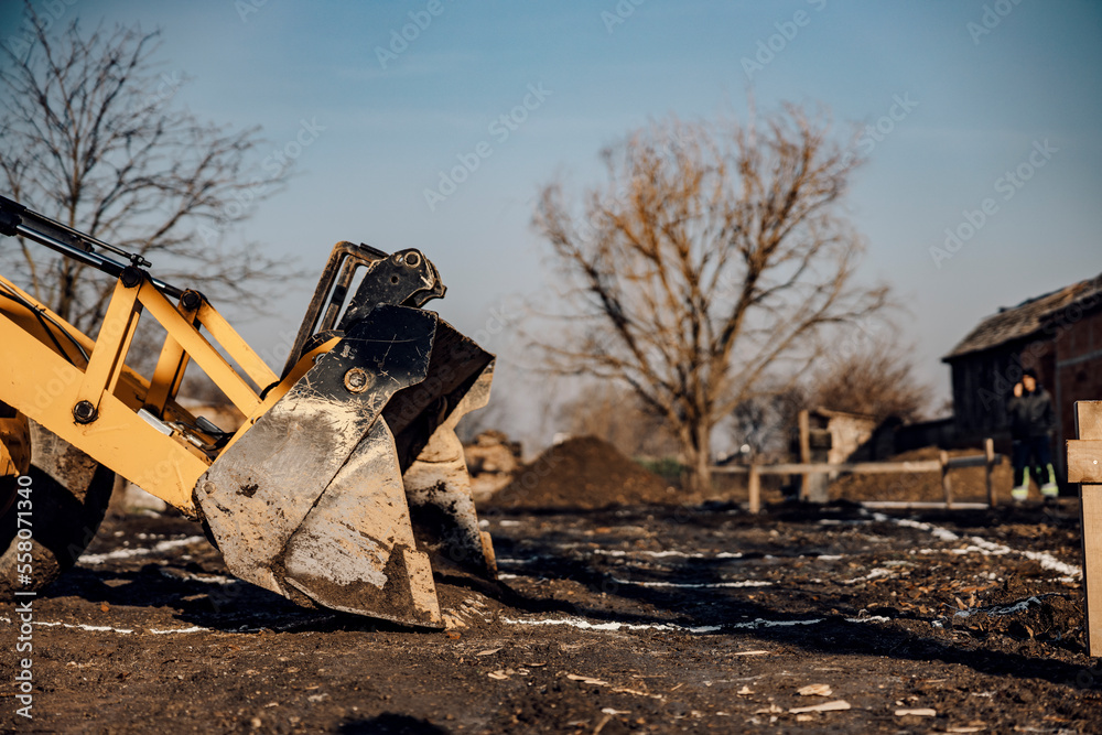Fototapeta premium An earthmover is digging earth on reconstruction area.