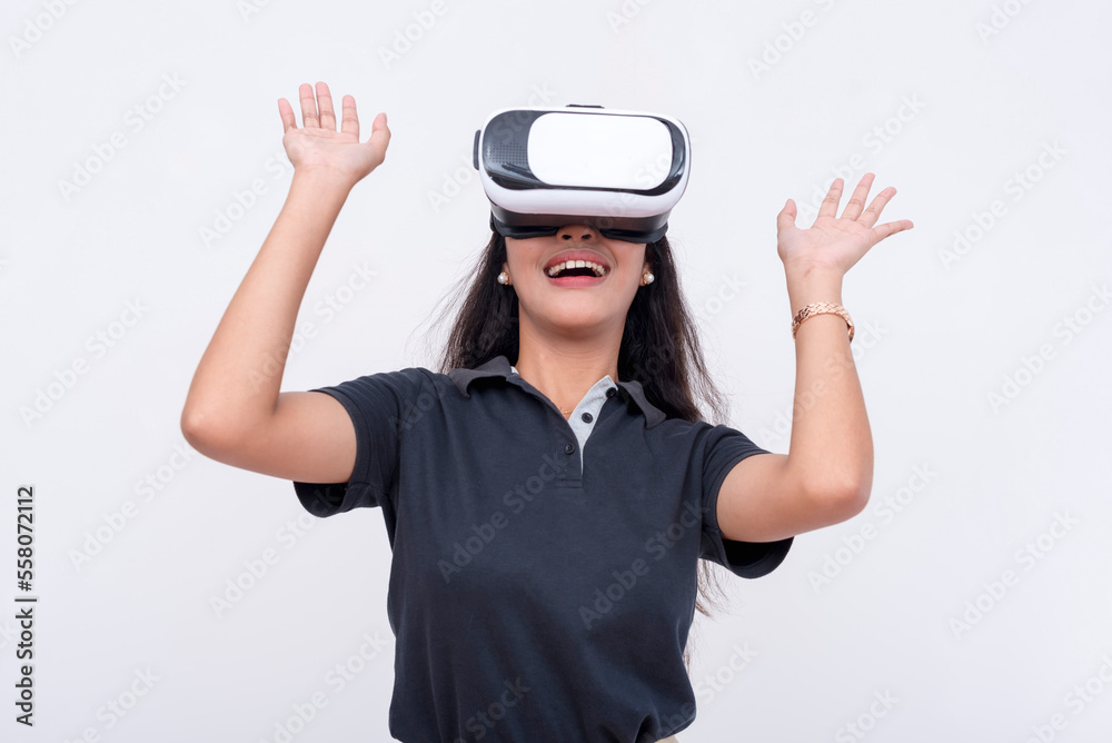 A young asian astonished and overwhelmed while exploring a VR environment via a virtual reality headset. Isolated on a white backdrop. A young asian astonished and overwhelmed while exploring a VR environment via a virtual reality headset. Isolated on a white backdrop.
