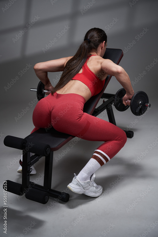 Athletic fitness woman working out, studio shot