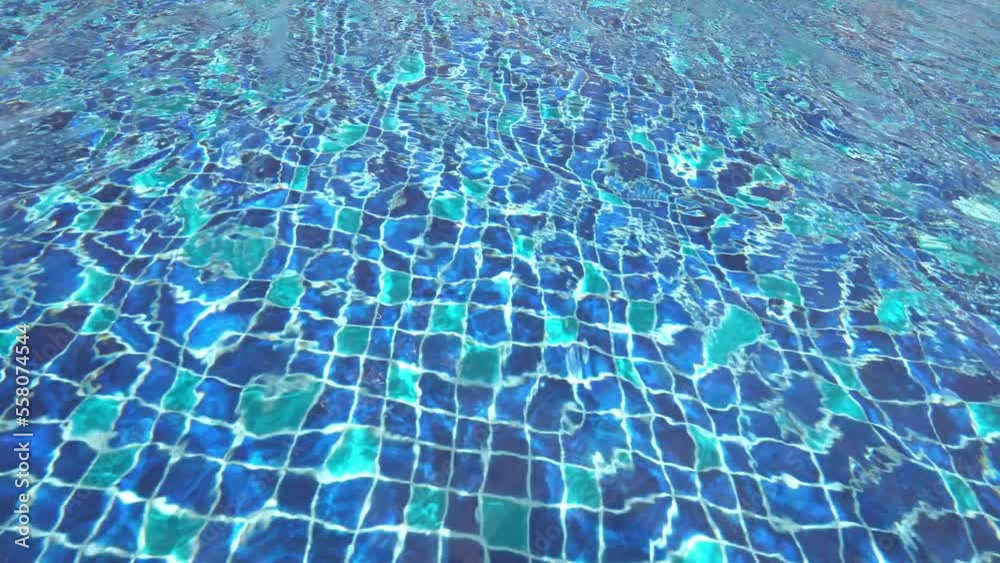 Water surface with waves on water surface wave effect You can see the blue square tiles at the bottom of the pool. Water surface with waves on water surface wave effect You can see the blue square tiles at the bottom of the pool.