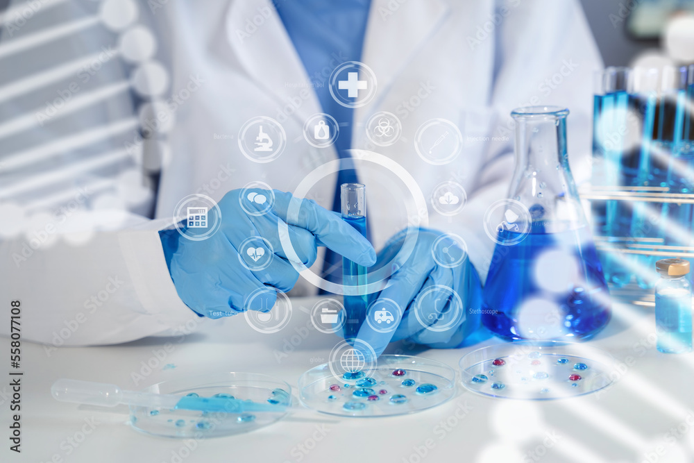 Fototapeta premium Female chemist scientist holding test tube and tablet conducting experiment in laboratory with equipment, science concept.
