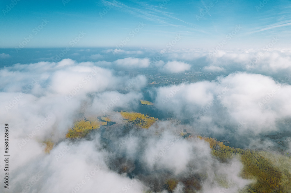 Aerial view of lake and wetland through clouds
