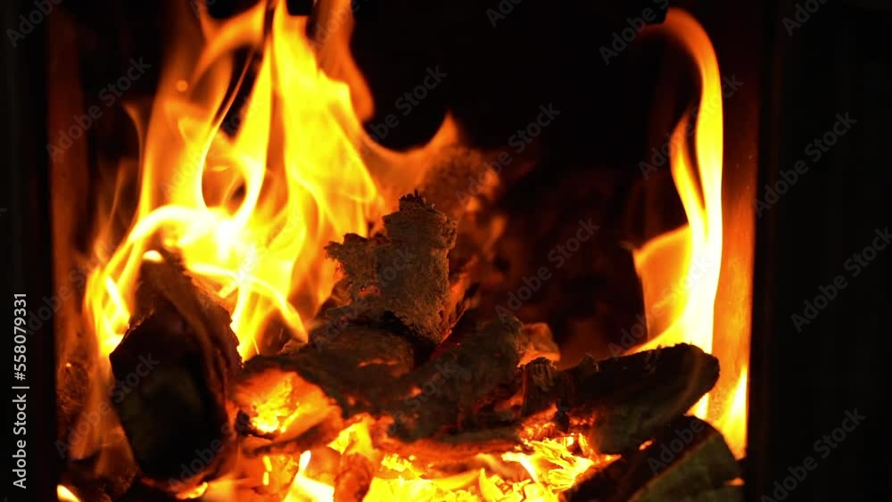 Flames burning in slow motion in furnace, firewood in blaze for heat Flames burning in slow motion in furnace, firewood in blaze for heat
