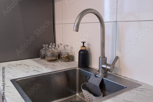 Kitchen sink with apron and chrome faucet