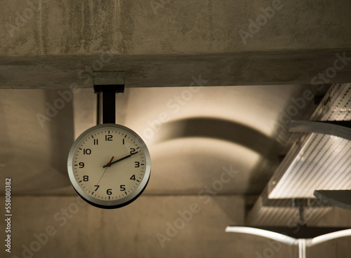 clock hanging on cement wall