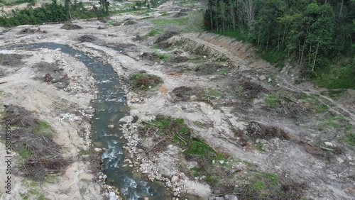 Aerial view of horrible deforestation for wood, logging, environmental destruction on mountain. Ecology concept change tree forest drought and forest refreshing, flying forward over a felled forest