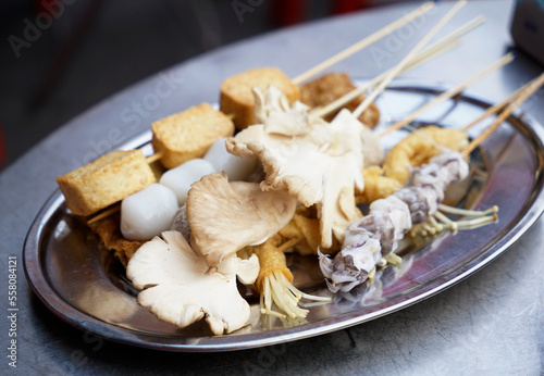 Mushrooms, tofu and squids on skewers ready for Malaysian hot pot                               