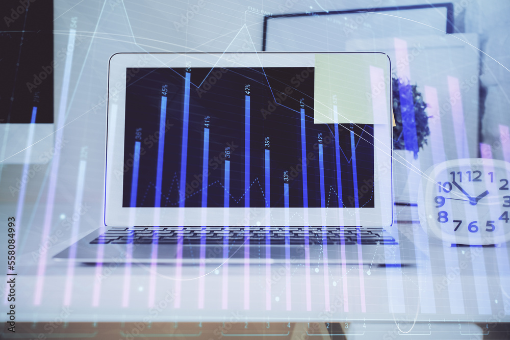 Forex Chart hologram on table with computer background. Double exposure. Concept of financial markets. Forex Chart hologram on table with computer background. Double exposure. Concept of financial markets.