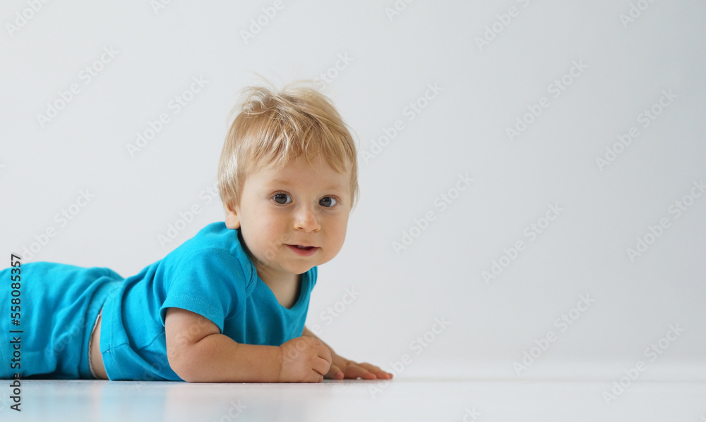 Little, happy and smiling cute baby in the studio. Portrait of a one year old baby. The concept of happiness.