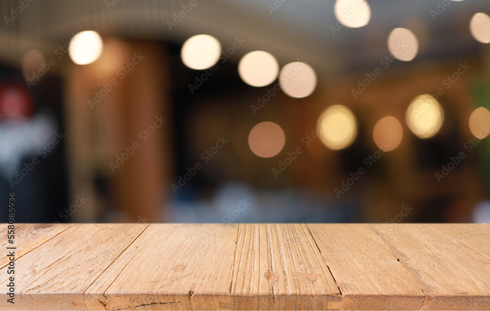 Empty wooden table in front of abstract blurred background of coffee shop . can be used for display or montage your products.Mock up for display of product Empty wooden table in front of abstract blurred background of coffee shop . can be used for display or montage your products.Mock up for display of product