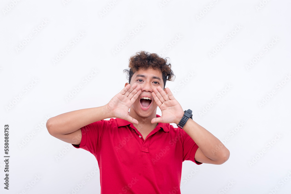 A man in his 20s yelling from the top of his lungs while looking straight at the camera. Isolated on a white background. A man in his 20s yelling from the top of his lungs while looking straight at the camera. Isolated on a white background.