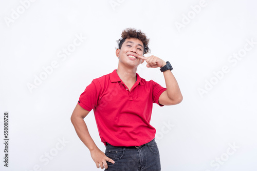 A confident young man showing off his complete teeth and nice, friendly smile. Isolated on a white background.