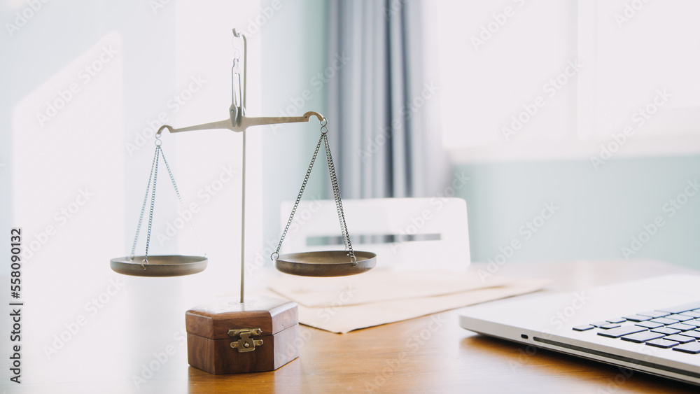Business and lawyers discussing contract papers with brass scale on desk in office. Law, legal services, advice, justice and law concept picture with film grain effect Business and lawyers discussing contract papers with brass scale on desk in office. Law, legal services, advice, justice and law concept picture with film grain effect