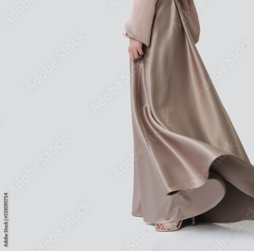 Studio shot of female fashion model in beige maxi circle skirt, Simplistic and elegant silk satin full length skirt