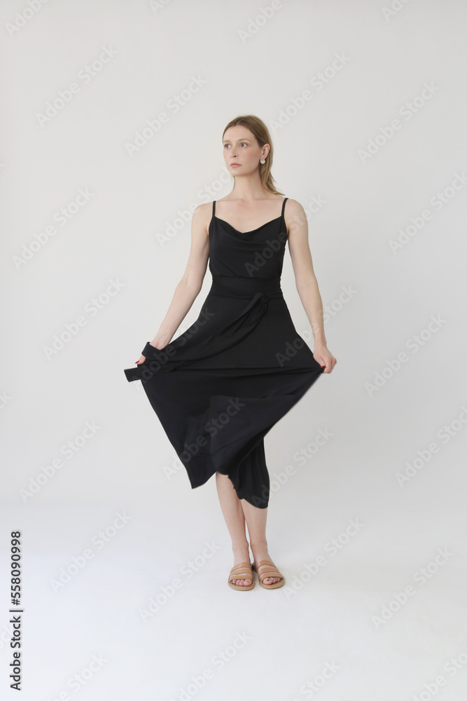 Serie of studio photos of young female model in comfortable yet stylish cotton black dress Serie of studio photos of young female model in comfortable yet stylish cotton black dress