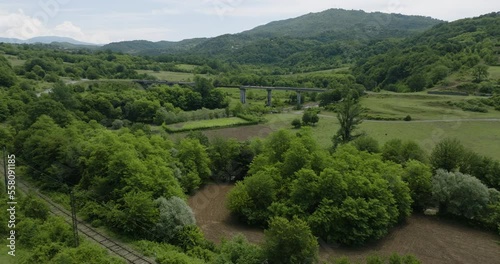 Railroad track and unfinished bridge in Tskaltsitela river countryside. photo