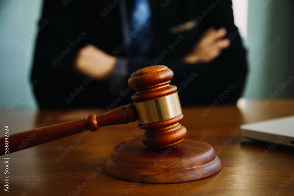 Business and lawyers discussing contract papers with brass scale on desk in office. Law, legal services, advice, justice and law concept picture with film grain effect Business and lawyers discussing contract papers with brass scale on desk in office. Law, legal services, advice, justice and law concept picture with film grain effect