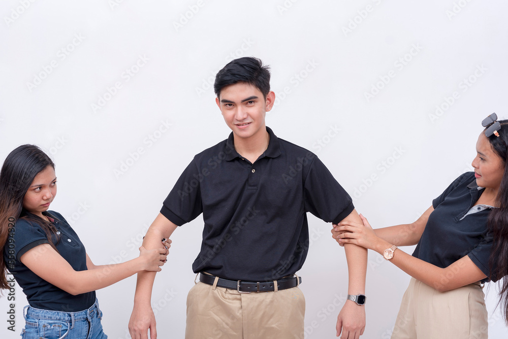 Two young women get get into a tugof war contest over an indifferent handsome man. Competing