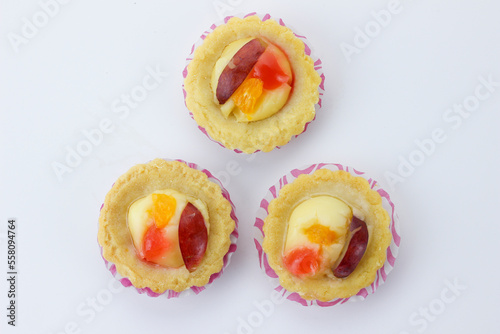 flat lay of mini fruit pie with orange slice and grape slices isolate on white background