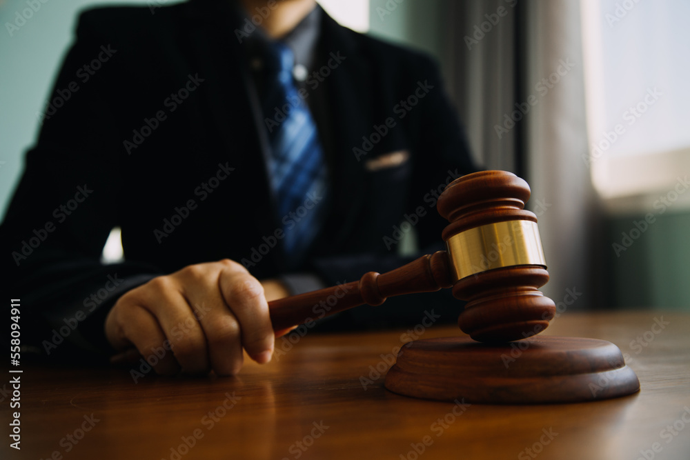 Business and lawyers discussing contract papers with brass scale on desk in office. Law, legal services, advice, justice and law concept picture with film grain effect Business and lawyers discussing contract papers with brass scale on desk in office. Law, legal services, advice, justice and law concept picture with film grain effect