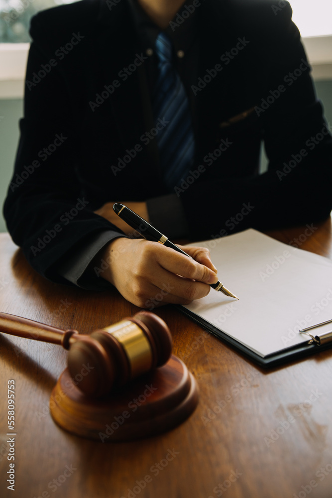 Business and lawyers discussing contract papers with brass scale on desk in office. Law, legal services, advice, justice and law concept picture with film grain effect Business and lawyers discussing contract papers with brass scale on desk in office. Law, legal services, advice, justice and law concept picture with film grain effect