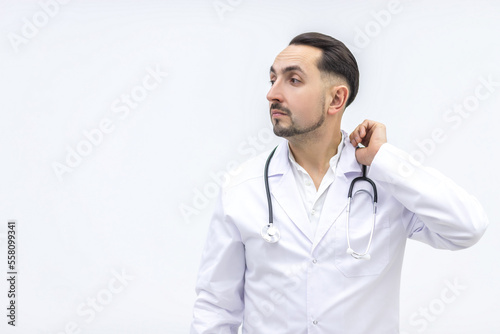 Close up photo of male mature doctor posing at camera with a stethoscope.