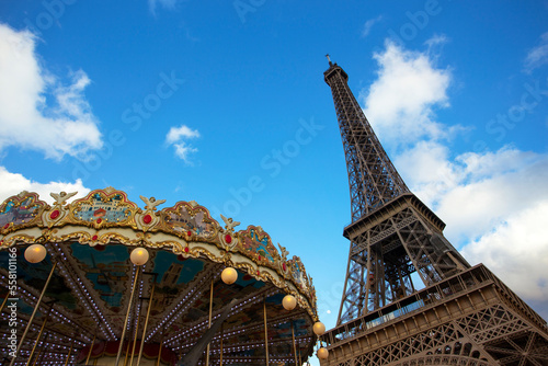 eiffel tower and carousel against the blue sky © Sergii Mostovyi